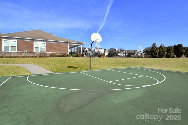 view of basketball court featuring a yard