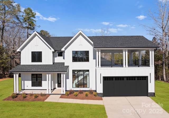 modern farmhouse with a front yard, a garage, a porch, and a balcony