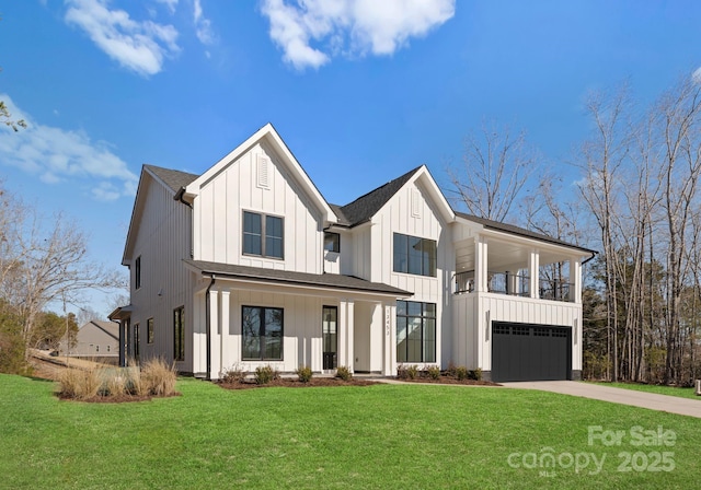 view of front of property featuring a garage, a front lawn, a balcony, and covered porch