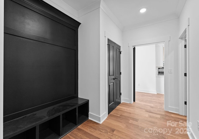 mudroom featuring hardwood / wood-style flooring and ornamental molding