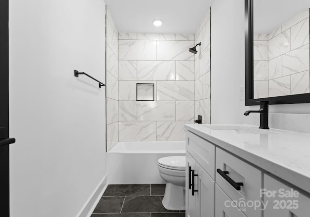 full bathroom featuring toilet, vanity, tiled shower / bath, and tile patterned flooring