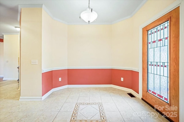 tiled spare room with baseboards, ornamental molding, and visible vents
