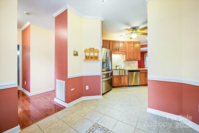 kitchen with a ceiling fan, light tile patterned floors, light countertops, appliances with stainless steel finishes, and visible vents