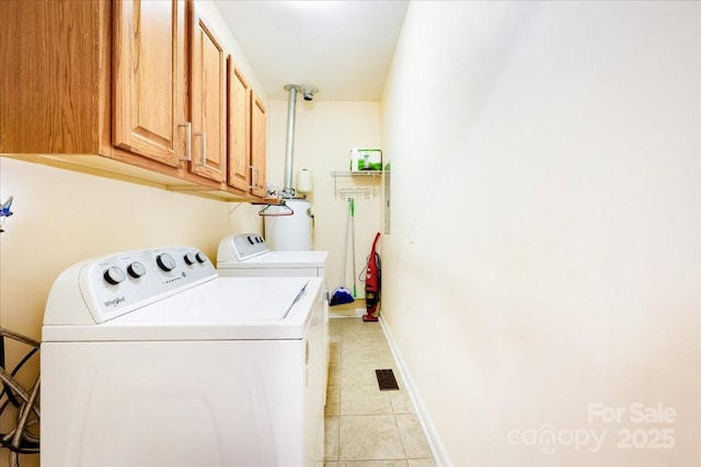 laundry room featuring cabinet space, washing machine and clothes dryer, baseboards, and light tile patterned floors