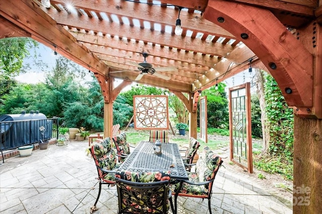view of patio featuring a pergola, outdoor dining space, and ceiling fan