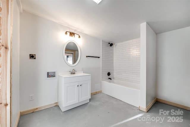 bathroom with vanity, tiled shower / bath, and concrete flooring