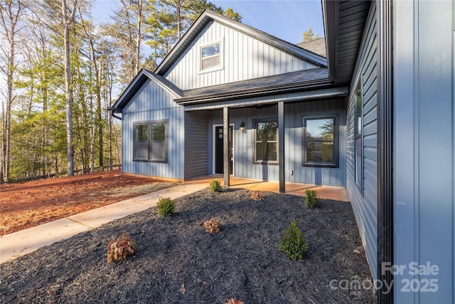 back of property with a porch