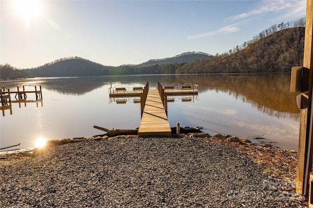 view of dock with a water and mountain view