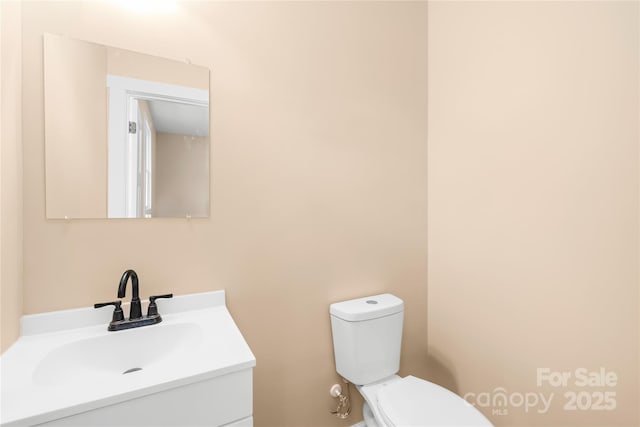 bathroom featuring toilet and vanity