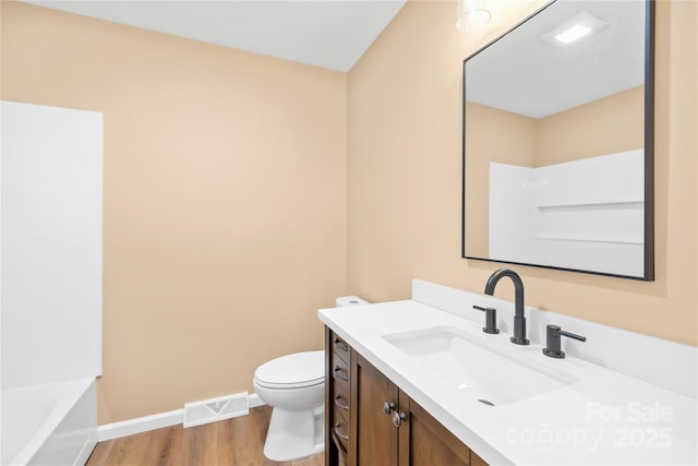 full bathroom with visible vents, baseboards, toilet, wood finished floors, and vanity