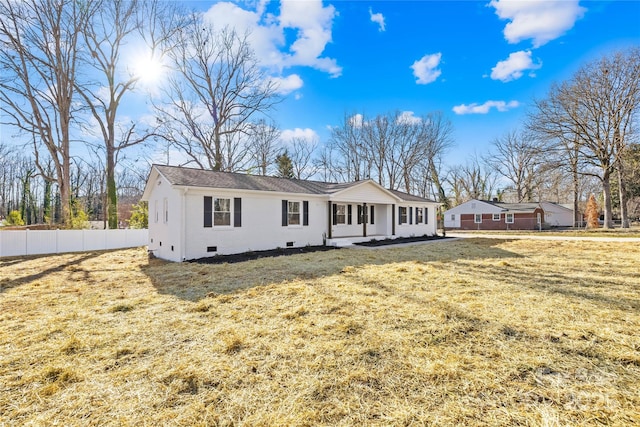 view of front of house with crawl space, a front lawn, and fence