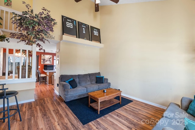 living room with ceiling fan and hardwood / wood-style floors