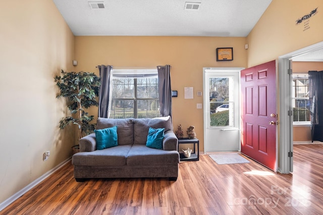 interior space with a textured ceiling and hardwood / wood-style flooring