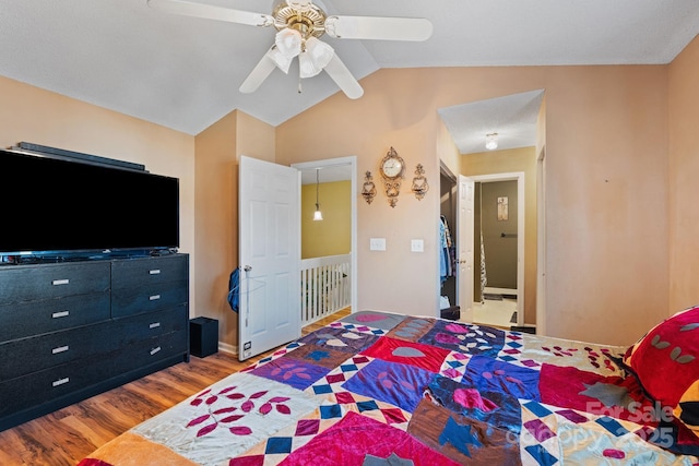 bedroom with ceiling fan, vaulted ceiling, and hardwood / wood-style flooring