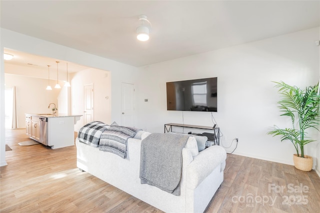 living room featuring light hardwood / wood-style floors and sink