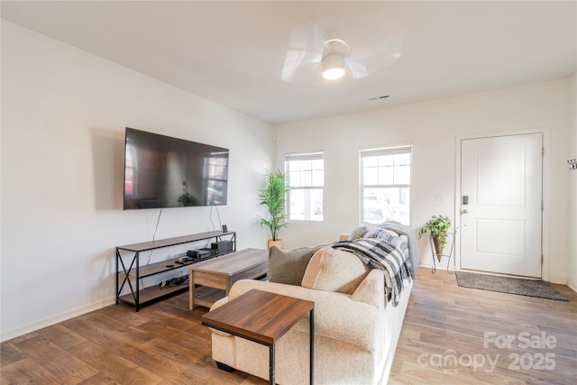 living room with ceiling fan and hardwood / wood-style floors