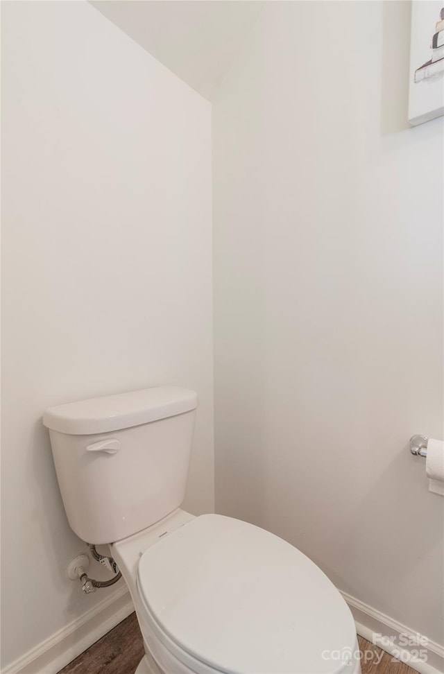 bathroom featuring hardwood / wood-style flooring and toilet