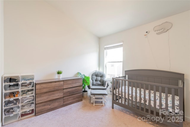 bedroom with a nursery area and vaulted ceiling