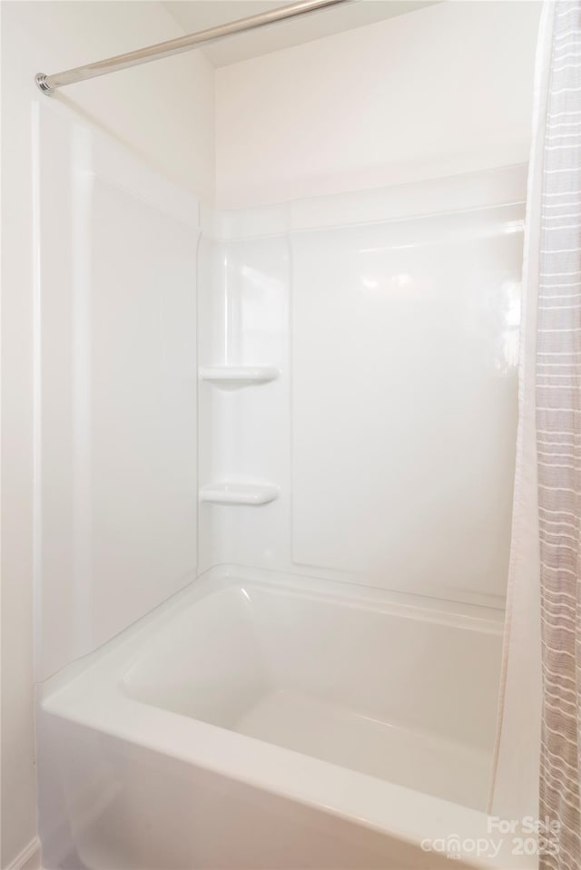 bathroom with shower / tub combo with curtain