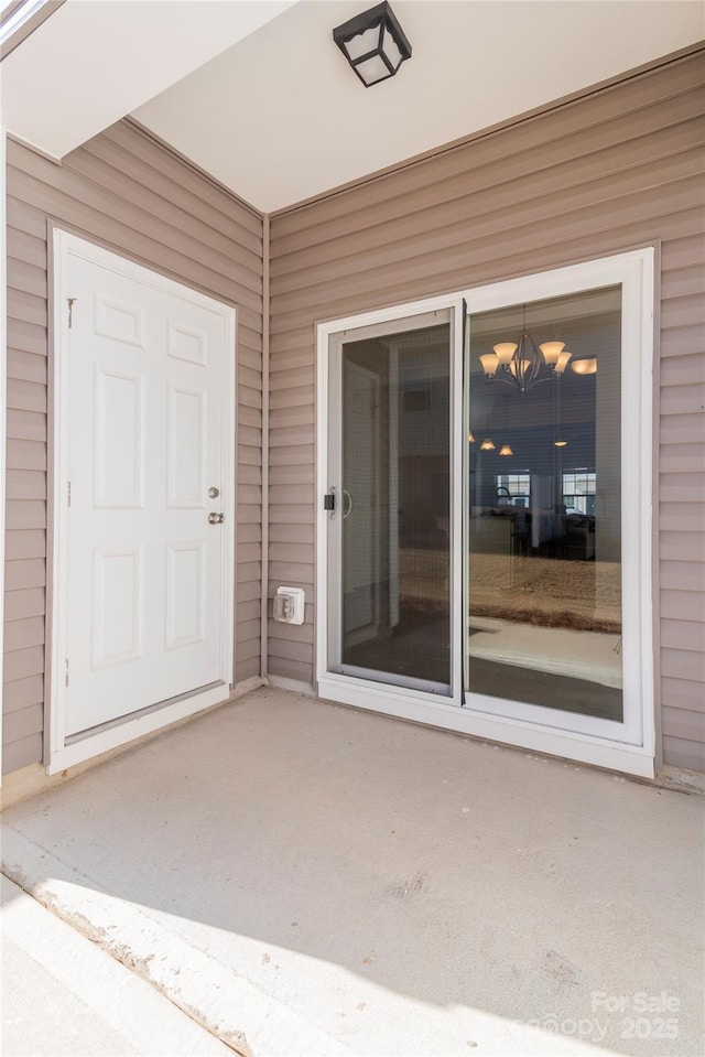 doorway to property with a patio area