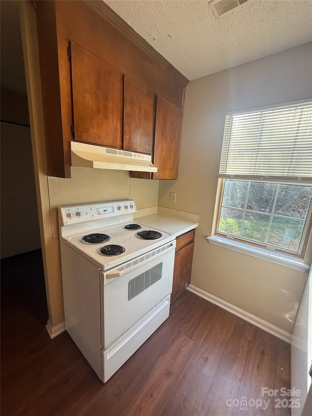 kitchen featuring a textured ceiling, dark hardwood / wood-style flooring, and white electric range