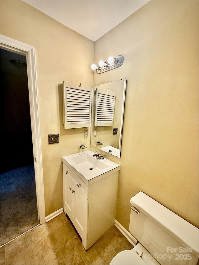 bathroom with toilet, radiator, and vanity