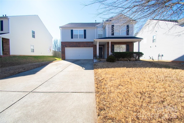 view of property featuring a porch, a garage, and a front yard