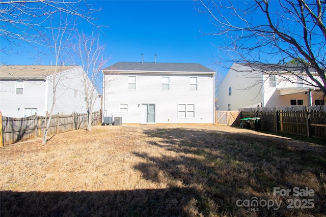 back of house with a yard and cooling unit