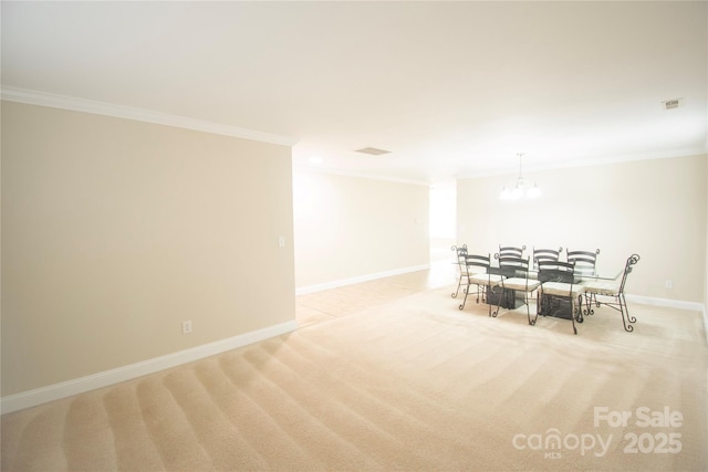 carpeted dining room with ornamental molding and a chandelier