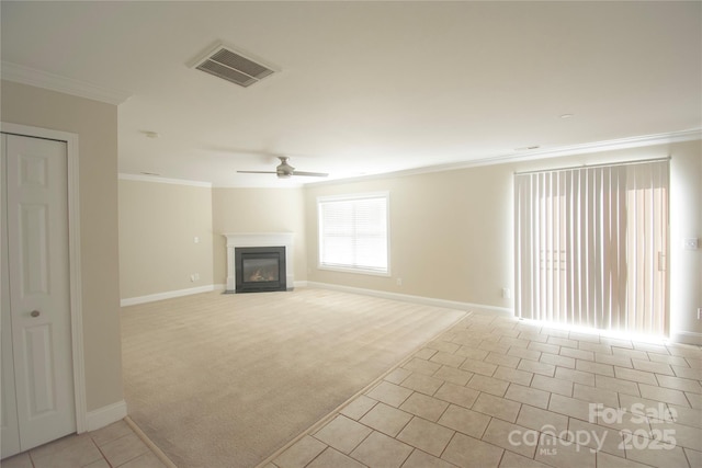 unfurnished living room with ceiling fan, light colored carpet, and crown molding