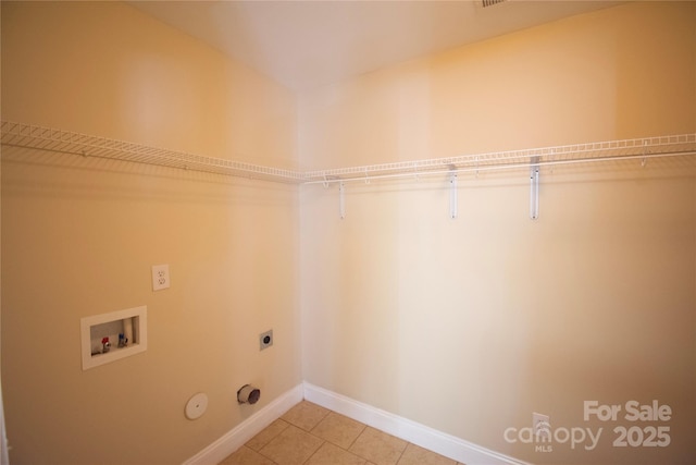 laundry area with gas dryer hookup, hookup for a washing machine, tile patterned floors, and hookup for an electric dryer