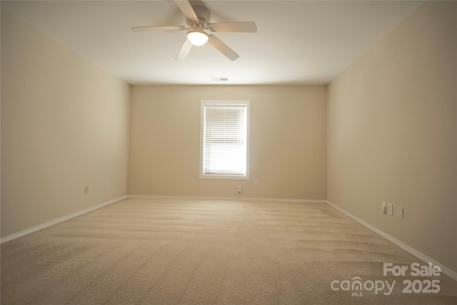 unfurnished room featuring light carpet and ceiling fan