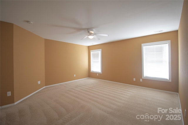 carpeted empty room featuring ceiling fan