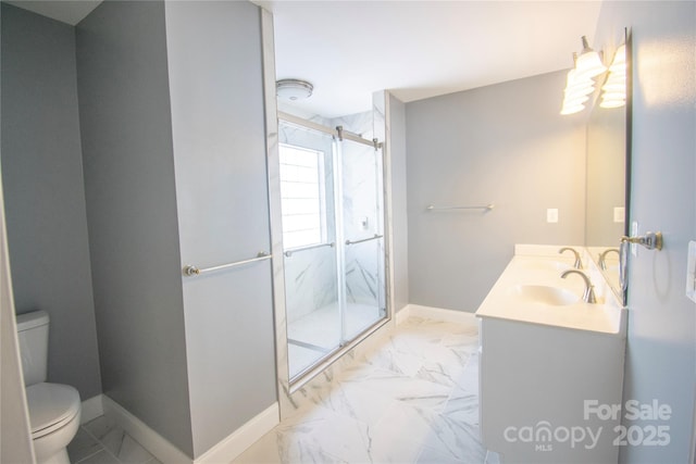 bathroom featuring vanity, toilet, and an enclosed shower