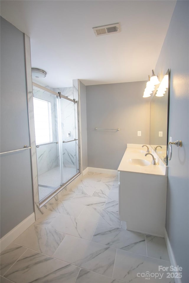 bathroom featuring vanity and an enclosed shower