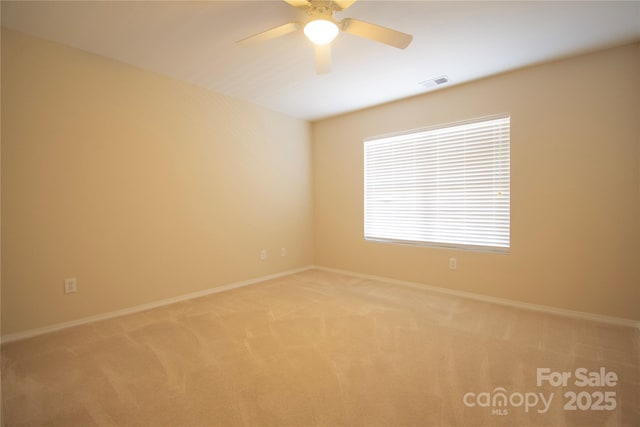 carpeted empty room featuring ceiling fan