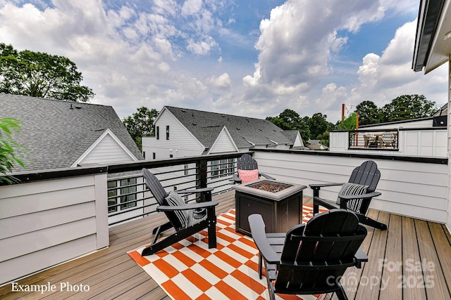 wooden deck with an outdoor fire pit