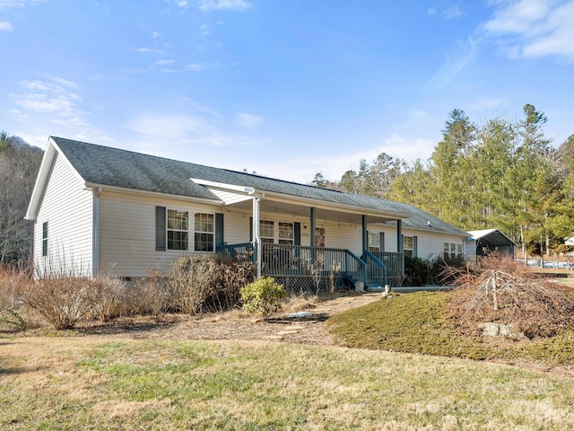 ranch-style house with a front lawn, a porch, and a carport