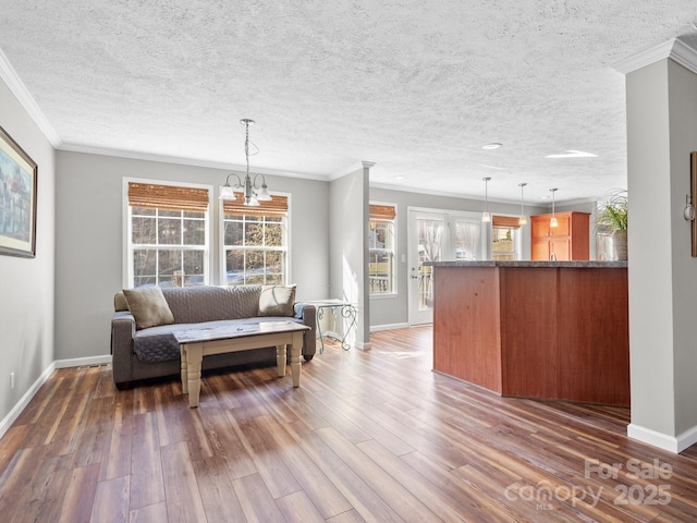 living room featuring dark hardwood / wood-style flooring, a wealth of natural light, and ornamental molding