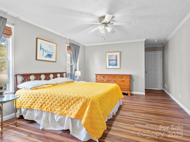 bedroom featuring a textured ceiling, ceiling fan, ornamental molding, and hardwood / wood-style floors