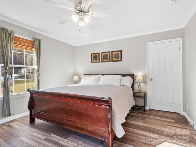 bedroom featuring ceiling fan, dark hardwood / wood-style flooring, and multiple windows