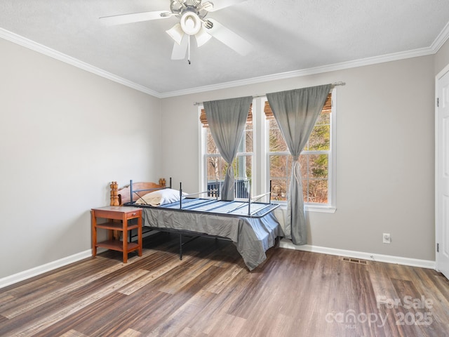 bedroom featuring ceiling fan, wood-type flooring, ornamental molding, and a textured ceiling