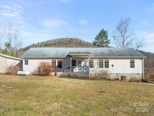 back of house with a lawn