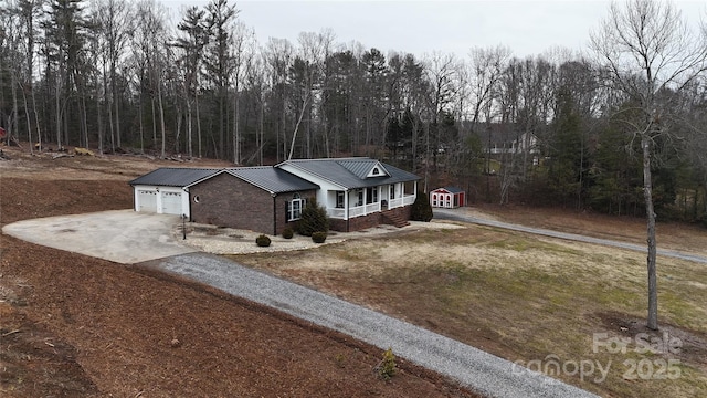 ranch-style house with a garage and a porch