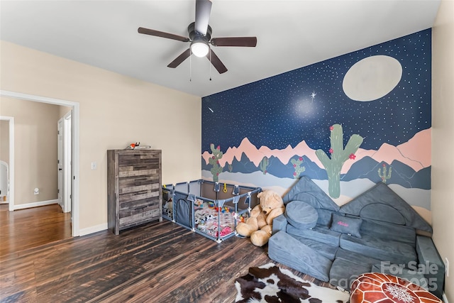 playroom featuring dark wood-type flooring and ceiling fan