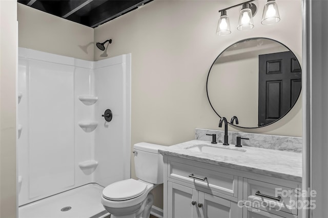 bathroom with vanity, toilet, and a shower