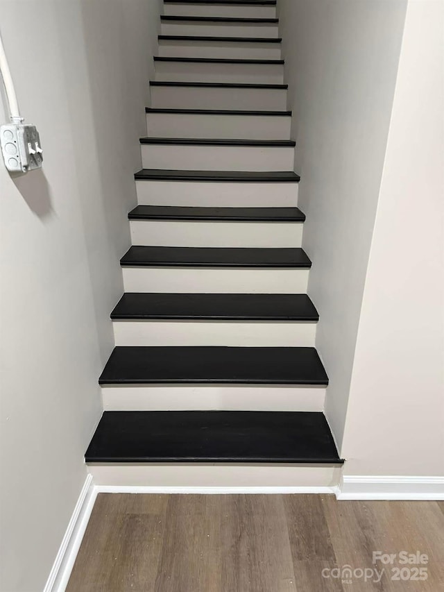 stairs featuring hardwood / wood-style floors