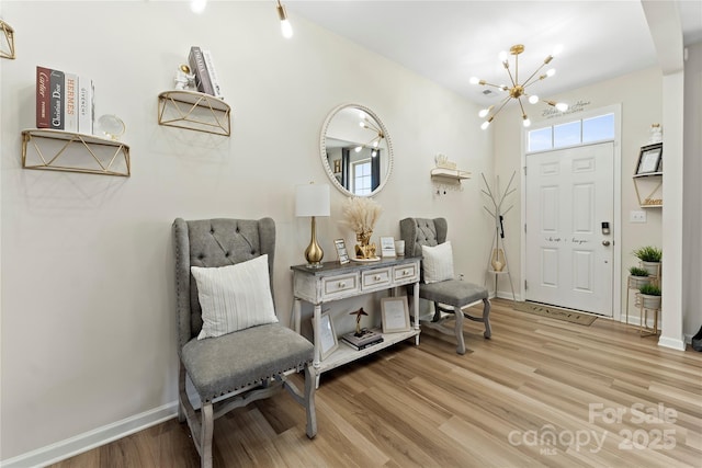 foyer with light hardwood / wood-style floors and a chandelier