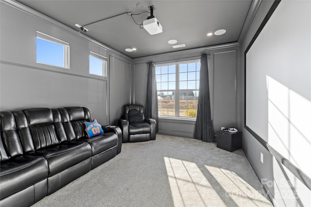 home theater featuring ornamental molding and light colored carpet