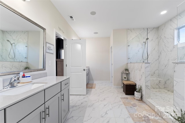 bathroom featuring vanity and tiled shower